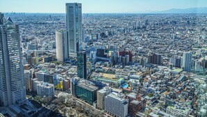 A cityscape with numerous high-rise buildings, a prominent skyscraper, and a dense urban layout. - 203_Shinjuku Gourmet&Shopping Recently (新宿区)