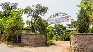A sign for The Riverine Stay, a MRC Tourism property, with a contact number and website. - The Riverine Stays by Igatpuri (Igatpuri)