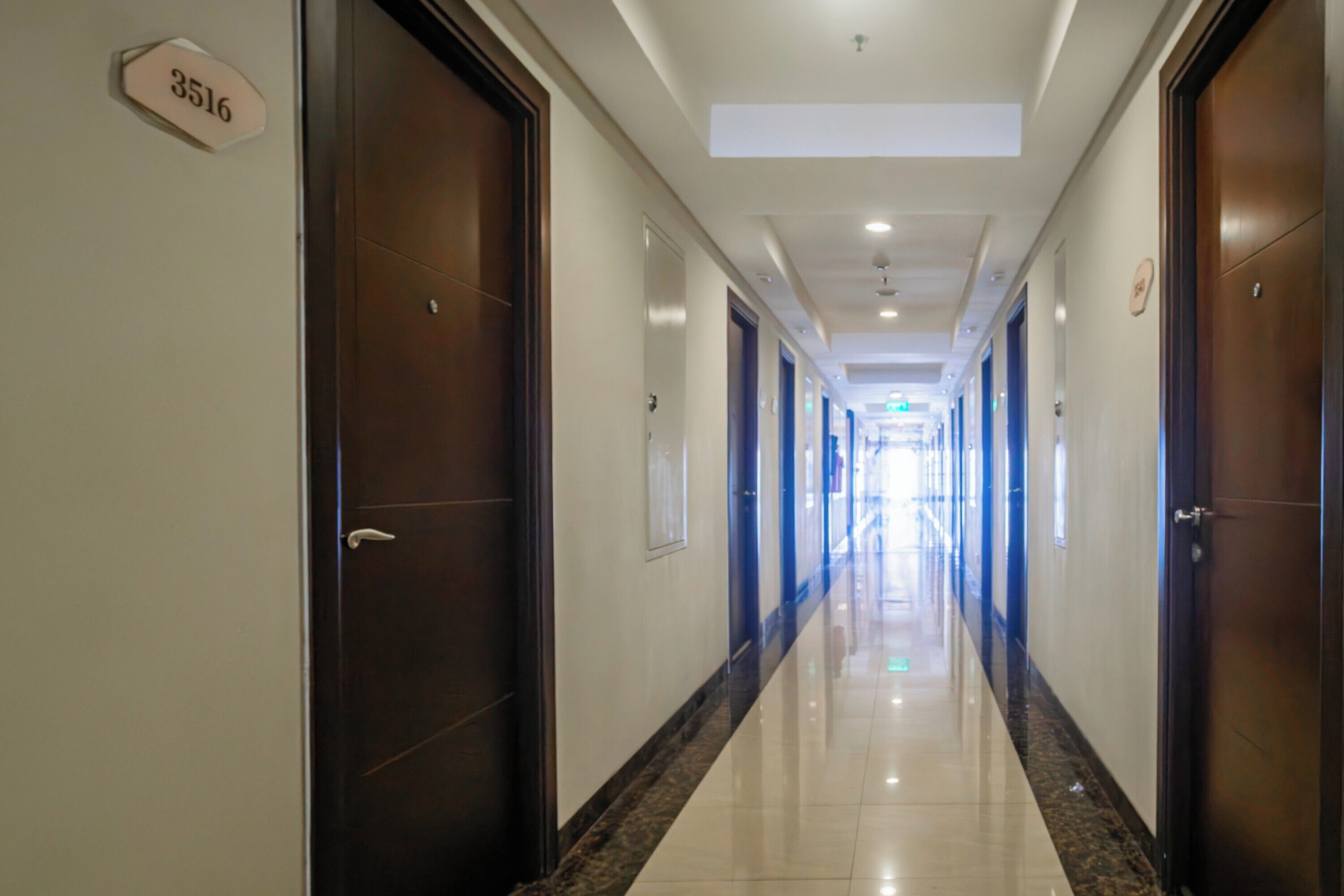 A hotel hallway with doors numbered 3516, leading to rooms.