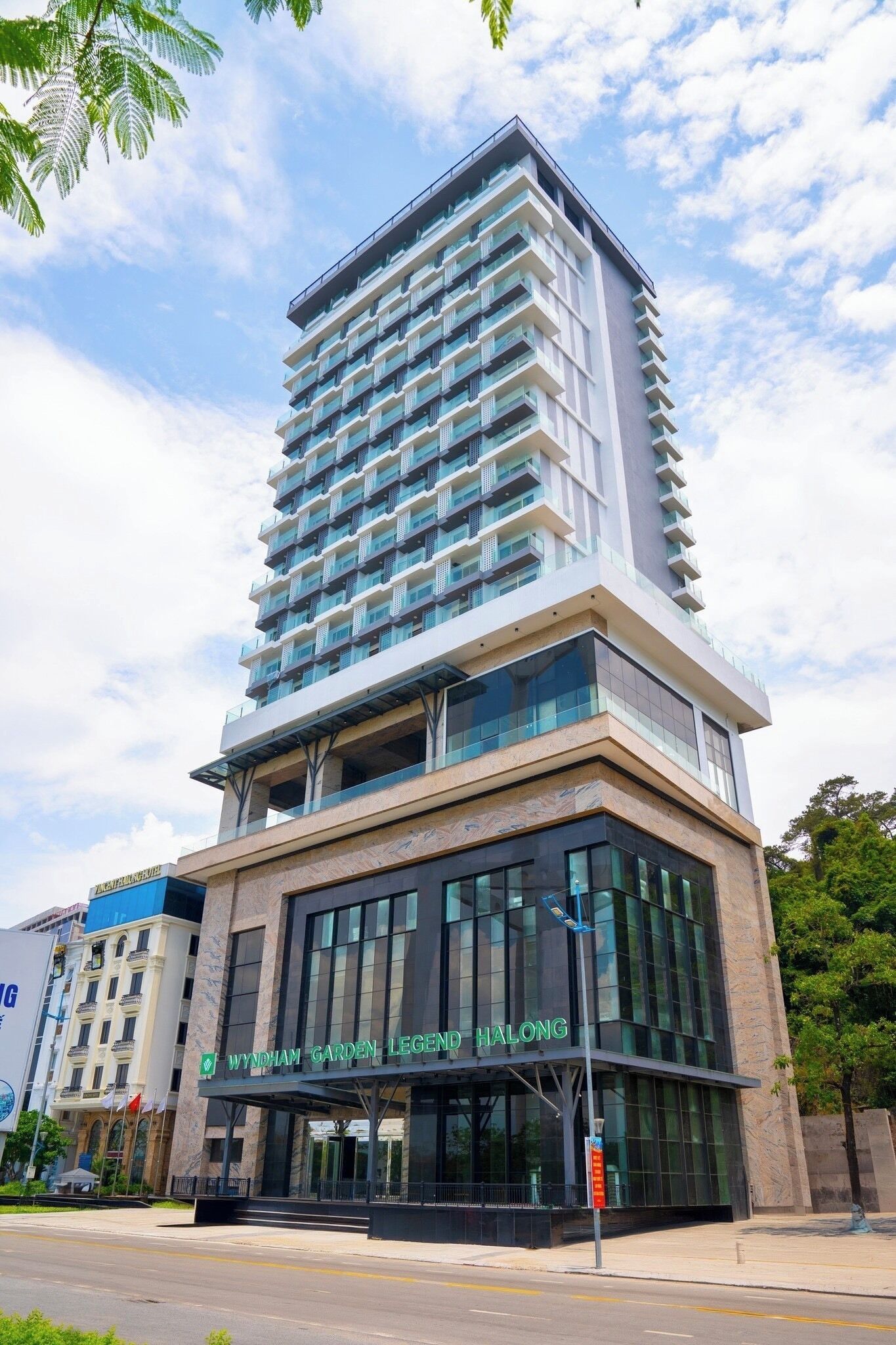 A modern hotel with a prominent entrance and a large glass facade.