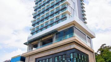 A modern hotel with a prominent entrance and a large glass facade.