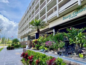 A hotel with a sign reading "Island Colony 445 Seaside."