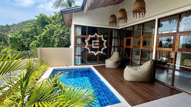A modern house with a swimming pool, wooden deck, and large glass windows. - La Balinaise (Chaweng Noi)