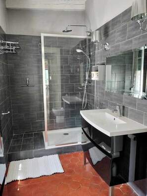 Regadera, secadora de cabello, toallas, papel de baño 