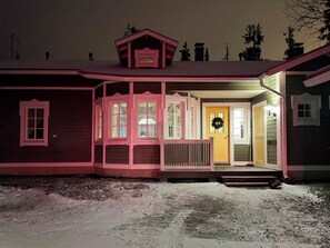 A house with a porch, a front door, and a wreath on the door.