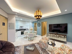 Deluxe Apartment, Balcony, City View | Living area | 50-inch Smart TV with digital channels