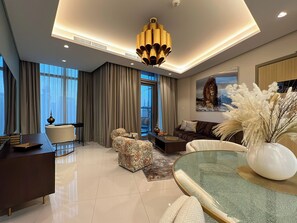 Deluxe Apartment, Balcony, City View | Living area | 50-inch Smart TV with digital channels - Burj Khalifa View Pool -1 BDR Paramount  (Dubai)