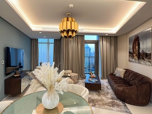 Deluxe Apartment, Balcony, City View | Living area | 50-inch Smart TV with digital channels