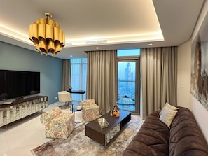 Deluxe Apartment, Balcony, City View | Living area | 50-inch Smart TV with digital channels - Burj Khalifa View Pool -1 BDR Paramount  (Dubai)