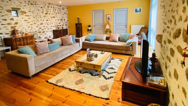 A living room with two sofas, a coffee table, and a television.