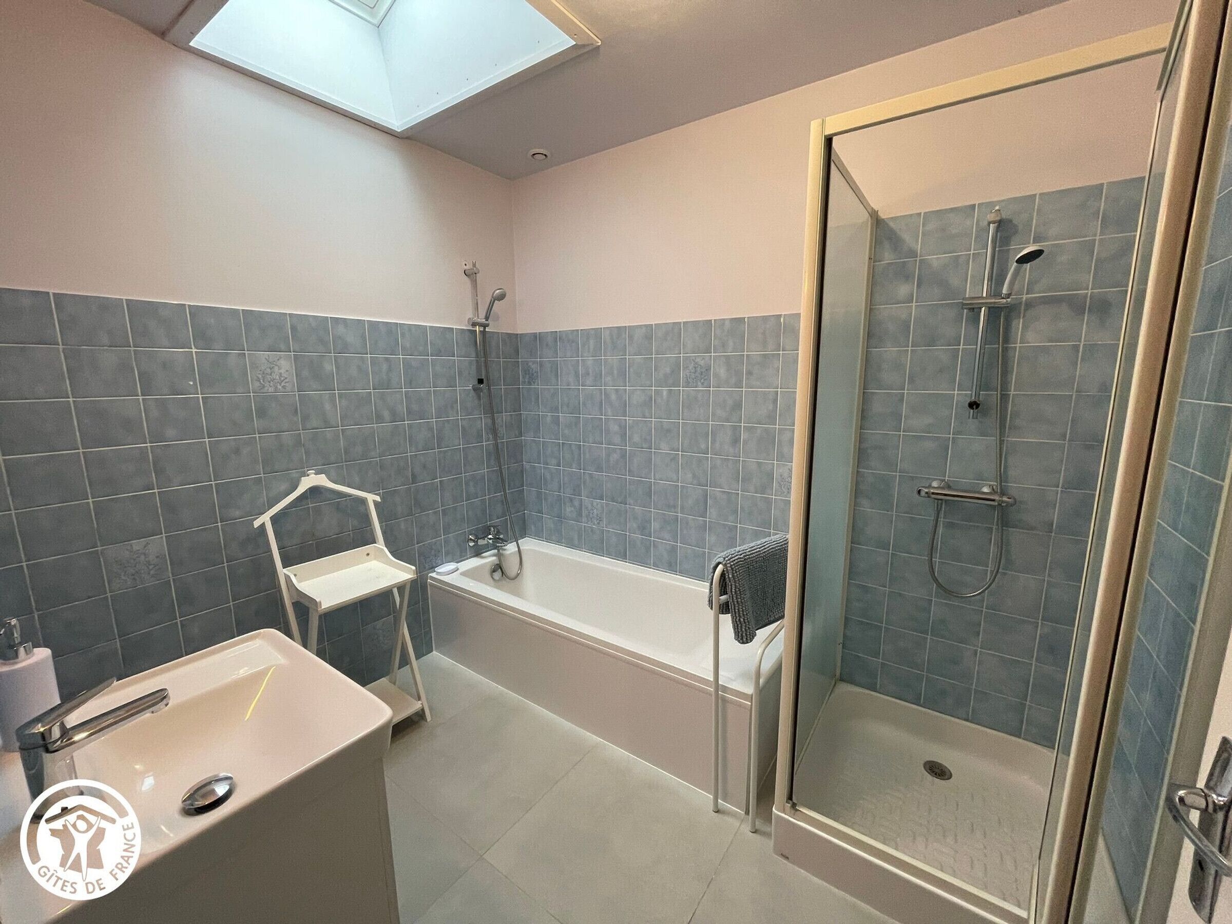 A bathroom with a bathtub, a shower, and a sink.