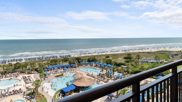 A resort with multiple swimming pools, beach access, and a view of the ocean. - Spectacular 8th Floor Serenity: Oceanfront Views (North Myrtle Beach)