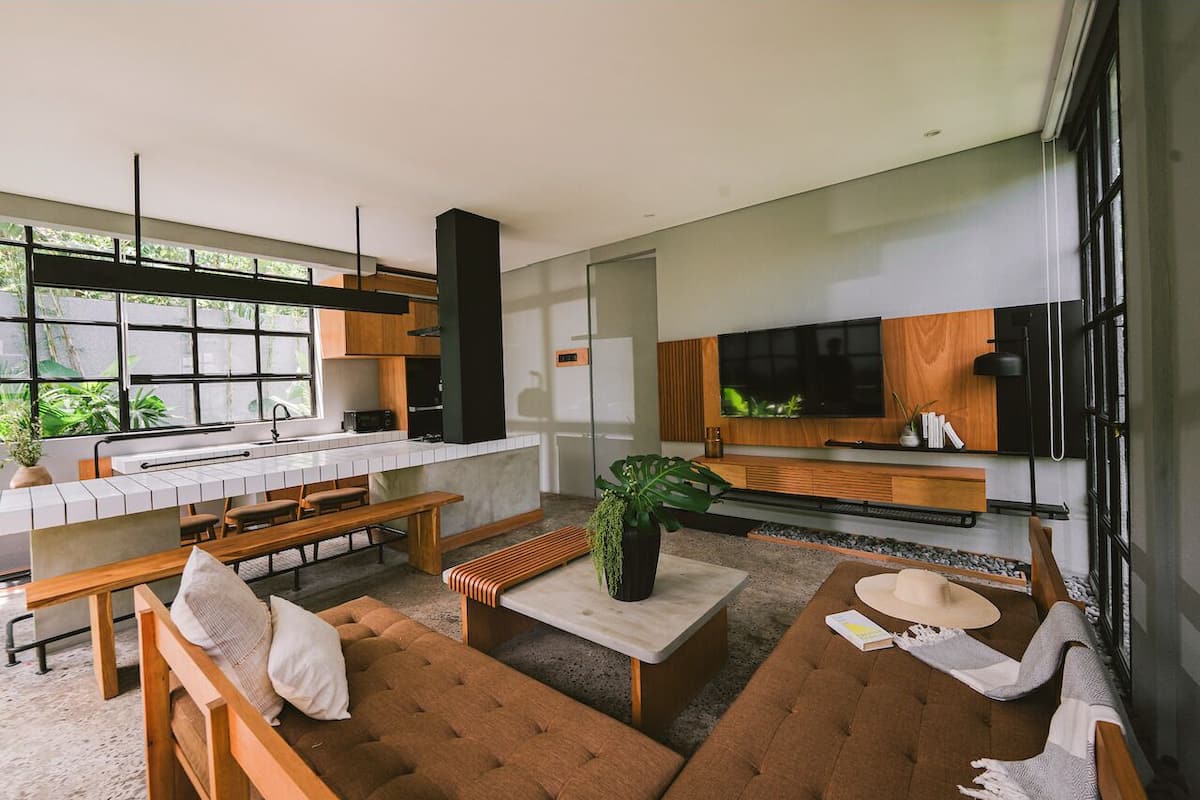 A modern living room with a sofa, coffee table, and a TV.