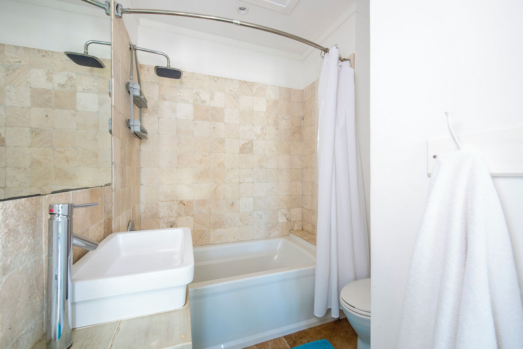 A bathroom with a shower, a bathtub, a toilet, and a sink.