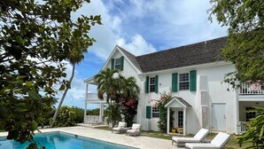 A large house with a swimming pool, outdoor seating, and a covered patio. - Hilltop Haven: Luxurious Historic Estate With Harbor Views (Governor's Harbour)