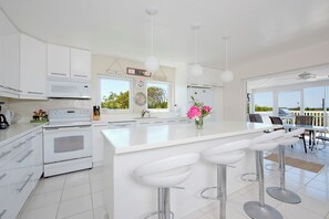 Villa | Private kitchen | Full-size fridge, microwave, oven, stovetop - Coastal Comfort: Charming Cottage With Private Pool (Governor's Harbour)