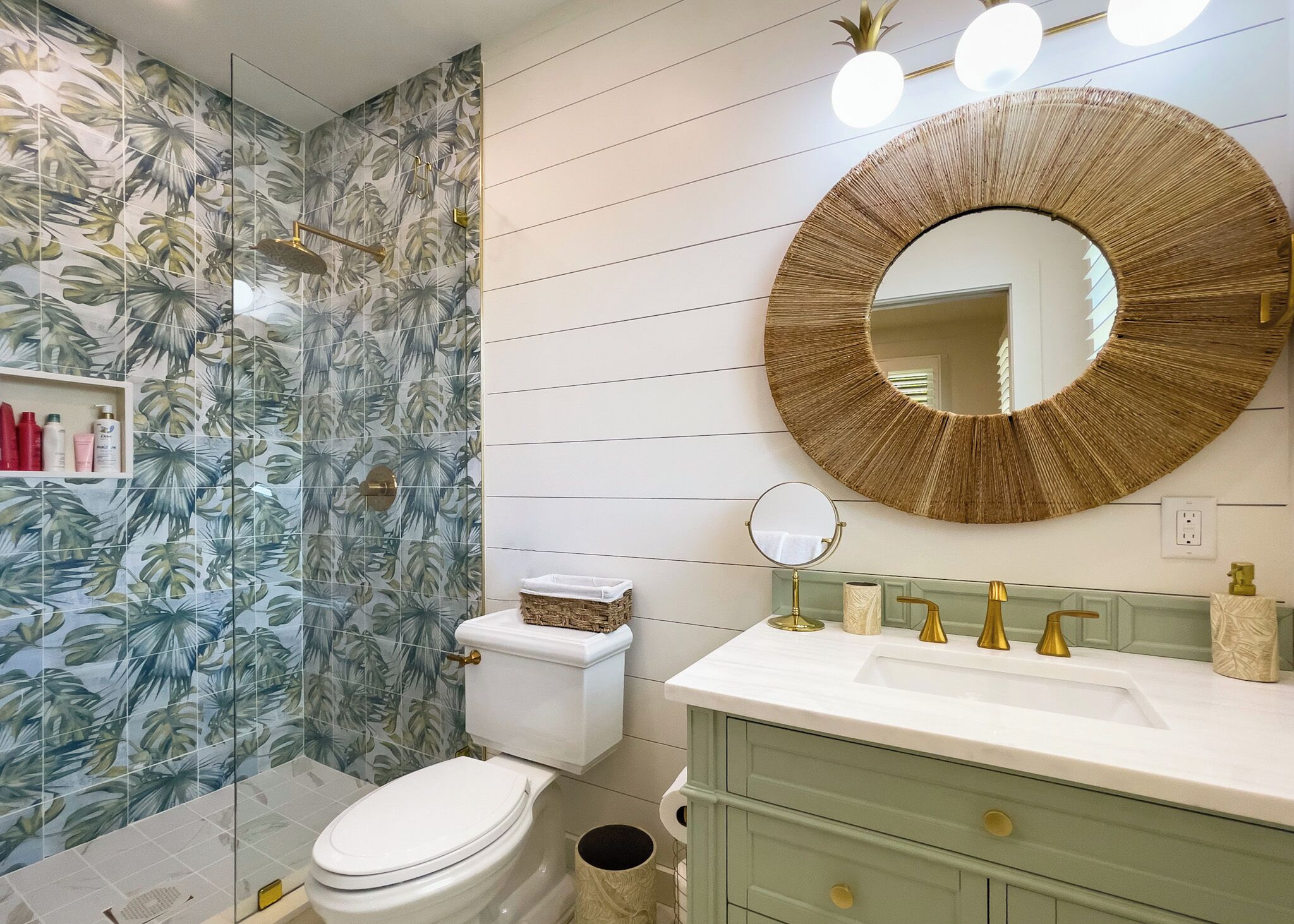 A bathroom with a toilet, sink, and mirror.