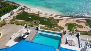 An aerial view of a resort with a swimming pool, landscaped areas, and a beach. - Beachfront Bliss: Private Retreat With Spectacular Views (Blowing Point)