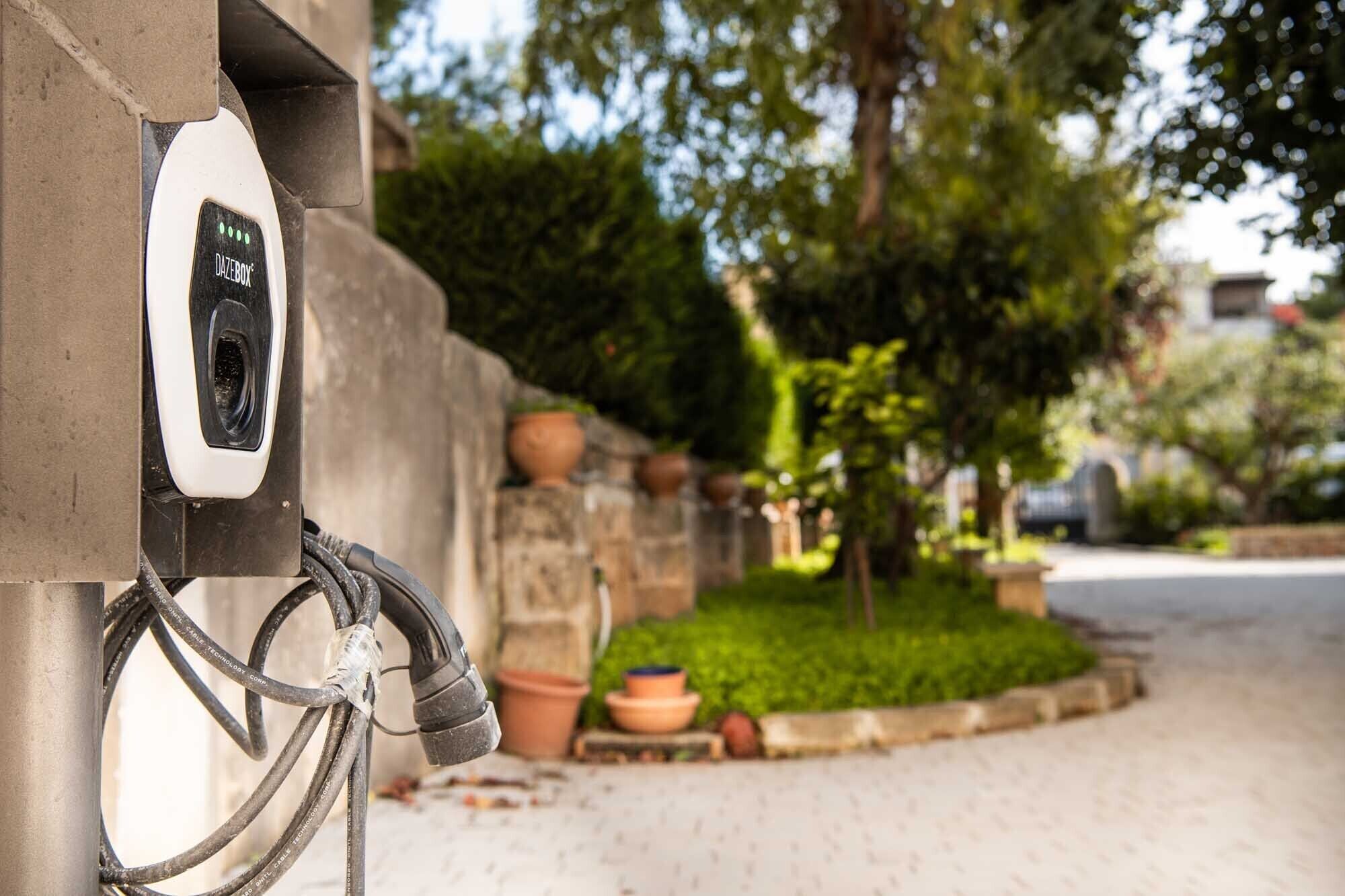 An electric vehicle charging station with a cable connected to a vehicle.