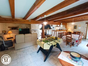 Relax in a warm and inviting space with a foosball table, TV, and fully equipped kitchen.