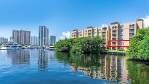 A waterfront hotel with a marina, high-rise buildings, and lush greenery. - Best view in Aventura Yacht Club, 2-bedroom condo fully equipped  (Aventura)
