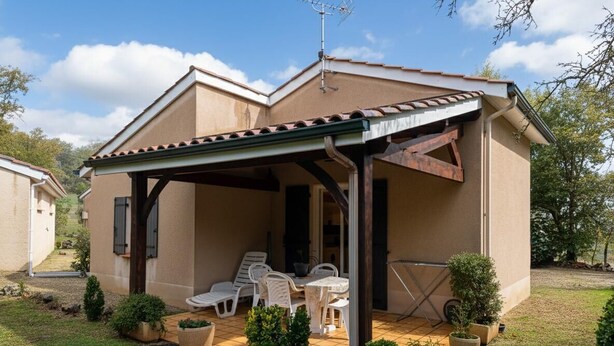 A single-story house with a covered patio, outdoor seating, and potted plants. - Gîtes de France® - 46G1905 (SAINT GERY-VERS)