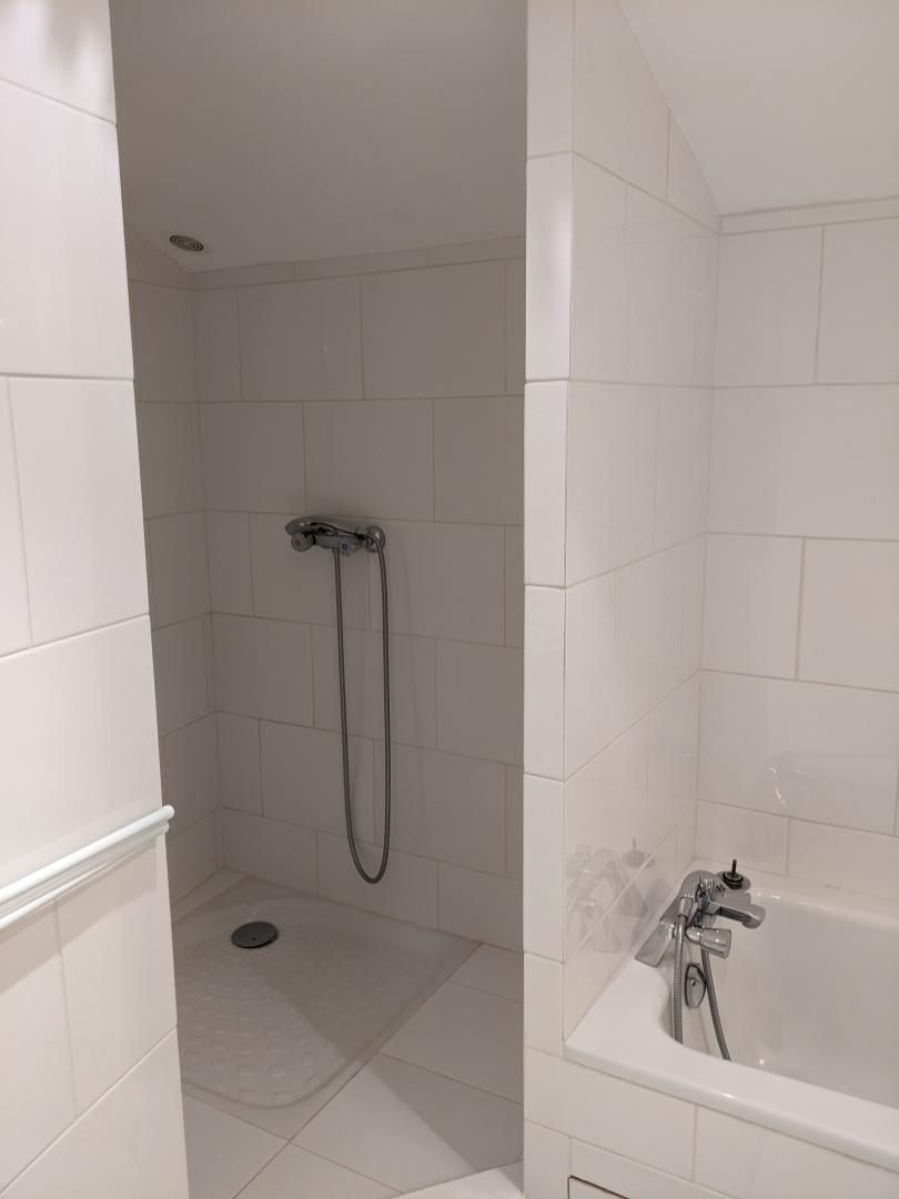 A bathroom with a shower, a bathtub, and a toilet.