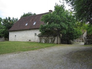 Set amidst a serene natural landscape, this charming farmhouse offers a peaceful retreat.