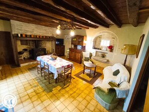 Cozy living area with a dining table for four, comfortable seating, and a fireplace.
