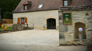A stone building with a sign reading "Gîte" and a website address. - Gîtes de France® - My Loft (ST CIRQ SOUILLAGUET)