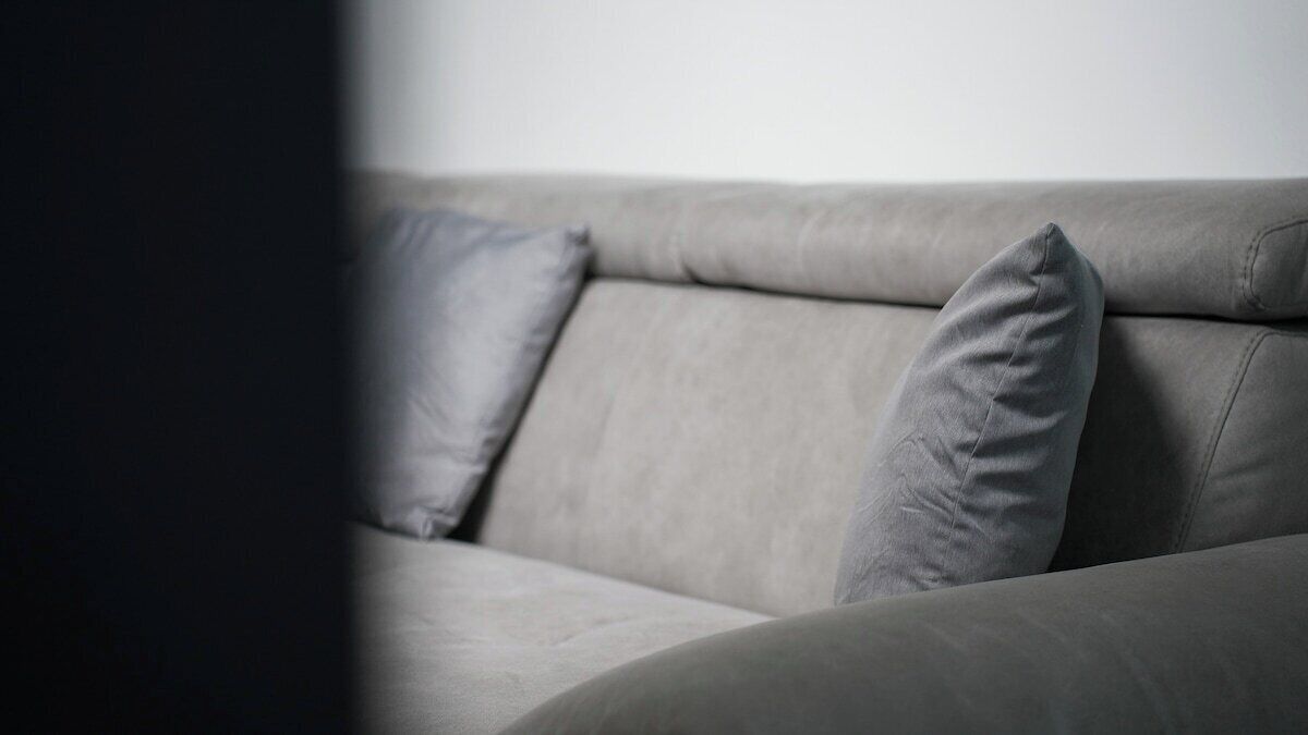 A grey sofa with two cushions.