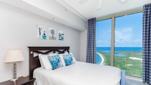 A bedroom with a large window offering a view of the landscape. - Last Minute Rates! P4-1202 - 2B Portofino Island Views! (Pensacola Beach)