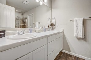 A modern bathroom with two sinks, a large mirror, and a towel rack. - 2BR w Swing bench Porch & BBQ | Garden of the Gods (Colorado Springs)