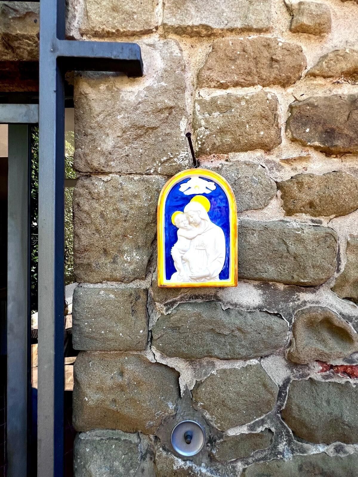 A stone wall with a religious icon.
