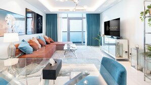 A modern living room with a sofa, coffee table, and TV. - Rooftop pool-2BR Apartment Near Downtown (Dubai)