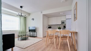 A modern apartment with a living room, dining area, and kitchen. - Forenom Serviced Apartments Klaukkala (Nurmijärvi)