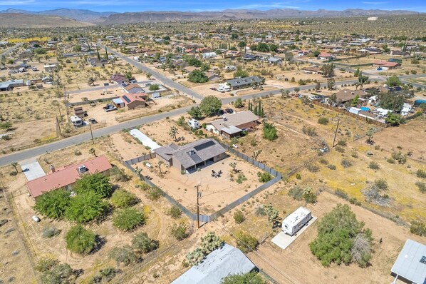 Vista aérea de una zona residencial con casas, calles y vegetación escasa.
