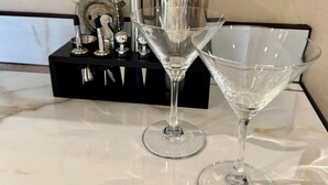 Two martini glasses on a marble countertop with a black tray holding various kitchen utensils. - Pet-Friendly I Rim Village I Garage I Pool & Hot Tub I Trailer Parking (Moab)