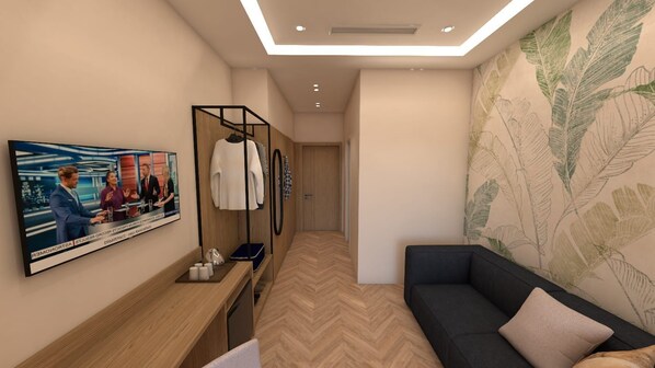 Suite estudio familiar | Minibar, caja de seguridad en la habitación y escritorio 
