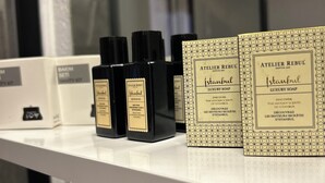 A shelf with bottles and boxes labeled 'Atelier Rebul Istanbul Luxury Soap'. - Milestone Otel (Ayvalik)