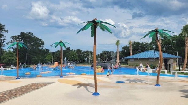 A water park with palm tree-shaped water features and a pool area. - Charming large 2-bedroom house 15 min to beach (Palm Coast)
