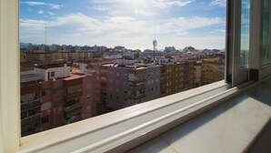 A view from a window overlooking a cityscape with multiple buildings and a clear sky. - La Noria Floor 1 (Torre Del Mar)