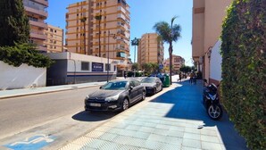 A street with parked cars and a sidewalk. - FANTASTIC FULLY RENOVATED APARTMENT (Torre Del Mar)