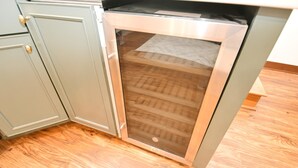 A kitchen with a built-in dishwasher and a wooden floor. - Updated Bungalow Steps to Notre Dame 410 (South Bend)