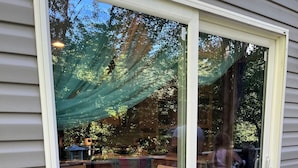 A sliding glass door leading to an outdoor patio with a table and chairs. - Modern 2-bdrm/2-bath mobile home, near Wildcat ATV Park, riders welcome! Wi-Fi! (Livingston)