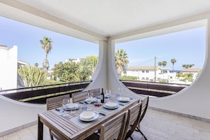 Enjoy meals in this elegant dining area with a table set for two, surrounded by a view of the residential street.