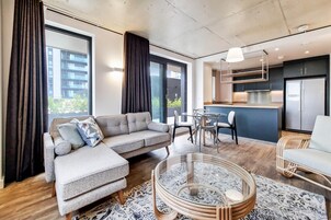 Apartment, 2 Bedrooms | Living area | 50-inch flat-screen TV with digital channels