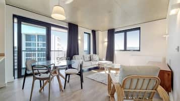 Apartment, 4 Bedrooms | Living area | 50-inch flat-screen TV with digital channels