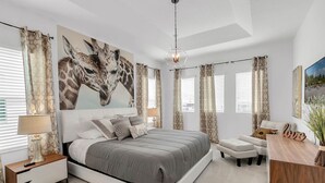 A bedroom with a large bed, a nightstand, a desk, and a chair. - Last Minute Disney! Private Pool, Hot Tub, Game Room & Themed Bedrooms. Book Now! #65969 (Orlando)