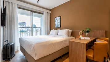 Signature Studio | Desk, laptop workspace, blackout drapes, iron/ironing board